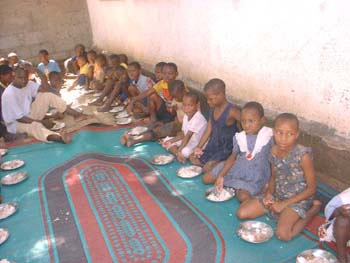 2005 Giving food for orphans in Tanzania.jpg